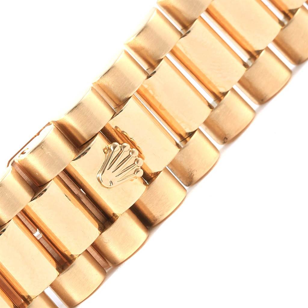 Close-up of the gold bracelet clasp of a Rolex President 118238 Men's Yellow Gold Blue Dial 118238 Men's Yellow Gold Blue Dial watch, showing the Rolex crown logo.