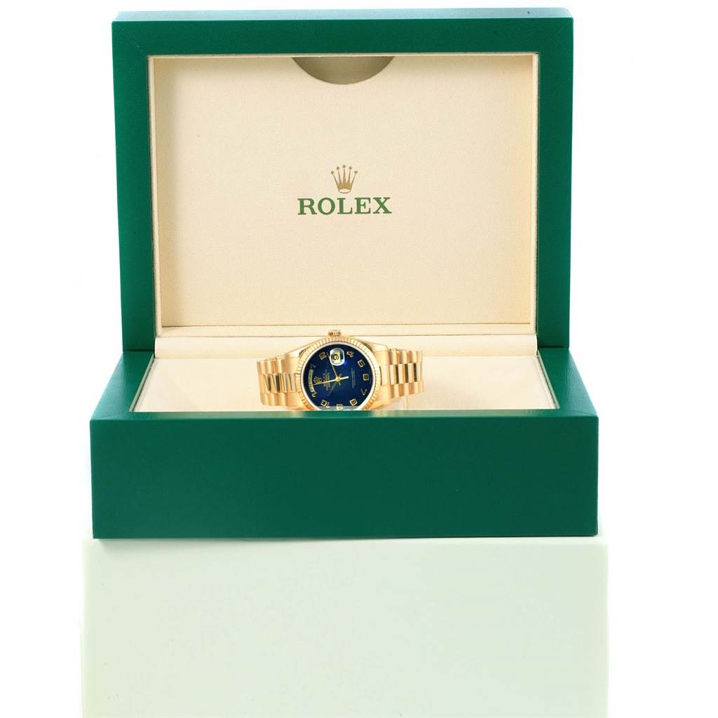 The image displays a front view of a Rolex President 118238 Men's Yellow Gold Blue Dial 118238 Men's Yellow Gold Blue Dial watch with a blue dial, housed in an open green Rolex box.