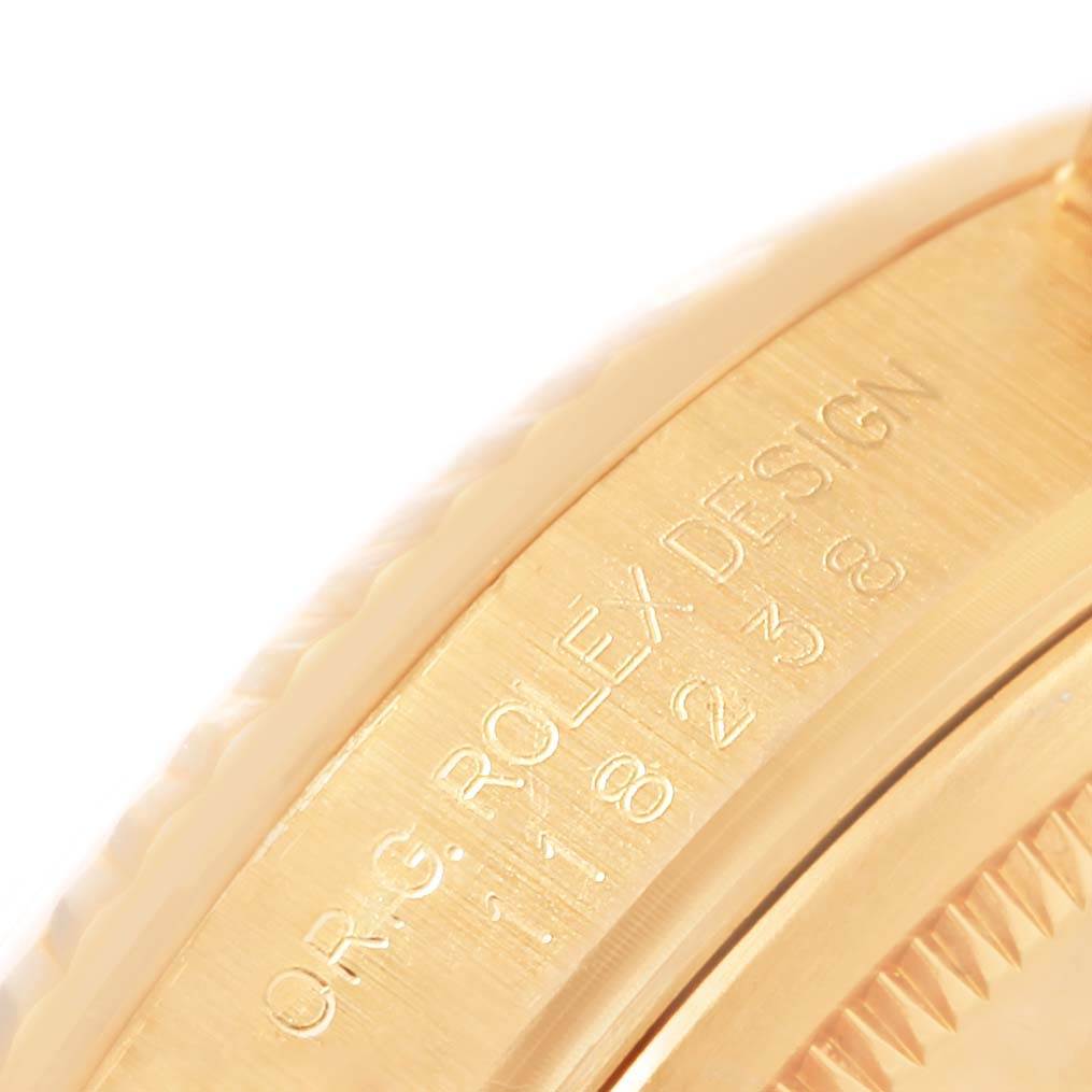 The image shows an angled close-up of the side of a Rolex President 118238 Men's Yellow Gold Blue Dial 118238 Men's Yellow Gold Blue Dial watch, highlighting its engraved details.