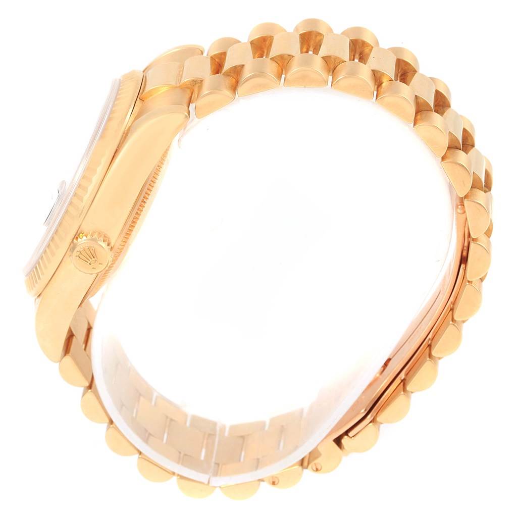 The side and part of the strap of the Rolex President 118238 Men's Yellow Gold Blue Dial 118238 Men's Yellow Gold Blue Dial watch model are shown at an angle.