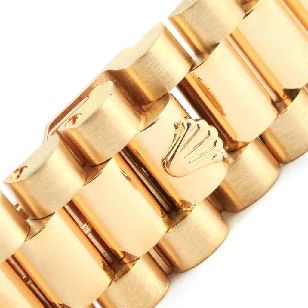 This close-up image showcases a section of the gold bracelet of the Rolex President 18238 Men
s Yellow Gold Champagne Dial 18238 Men
s Yellow Gold Champagne Dial model, highlighting the distinctive Rolex crown emblem.