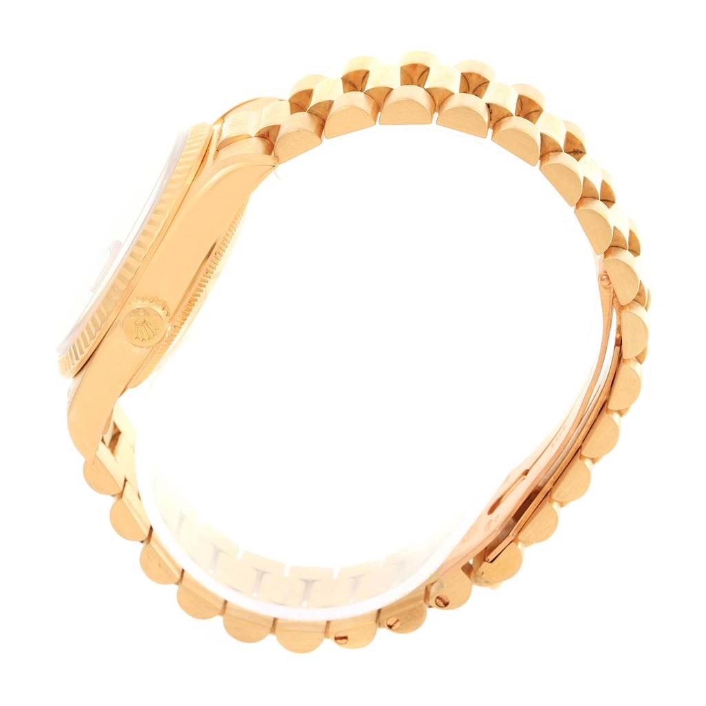 The image shows a side view of a Rolex President 18238 Men
s Yellow Gold Champagne Dial 18238 Men
s Yellow Gold Champagne Dial model watch, highlighting its case, crown, and gold bracelet.