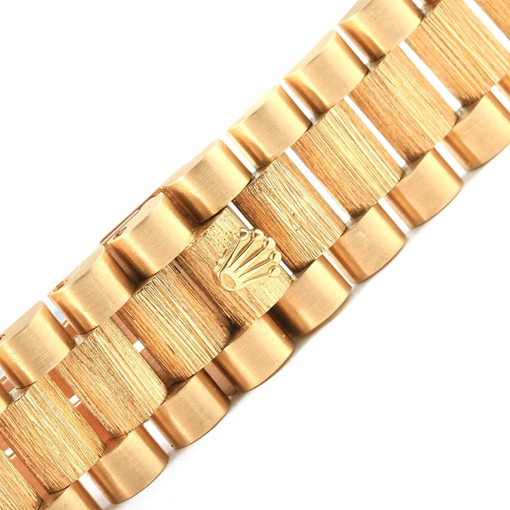 This image shows a close-up of the gold bracelet links of a Rolex President 18248 Men
s Yellow Gold Champagne Dial 18248 Men
s Yellow Gold Champagne Dial model watch, highlighting the Rolex crown logo.