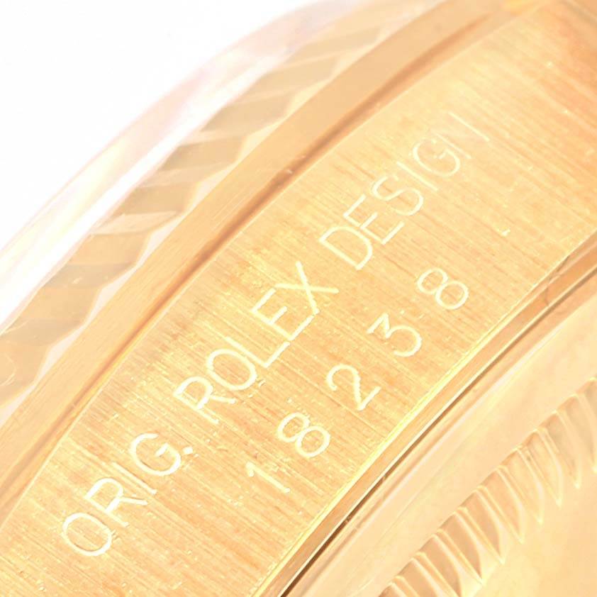 The image shows a close-up of the side inscription and the edge of the bezel of the Rolex President 18238 Men
s Yellow Gold White Dial 18238 Men
s Yellow Gold White Dial model watch.