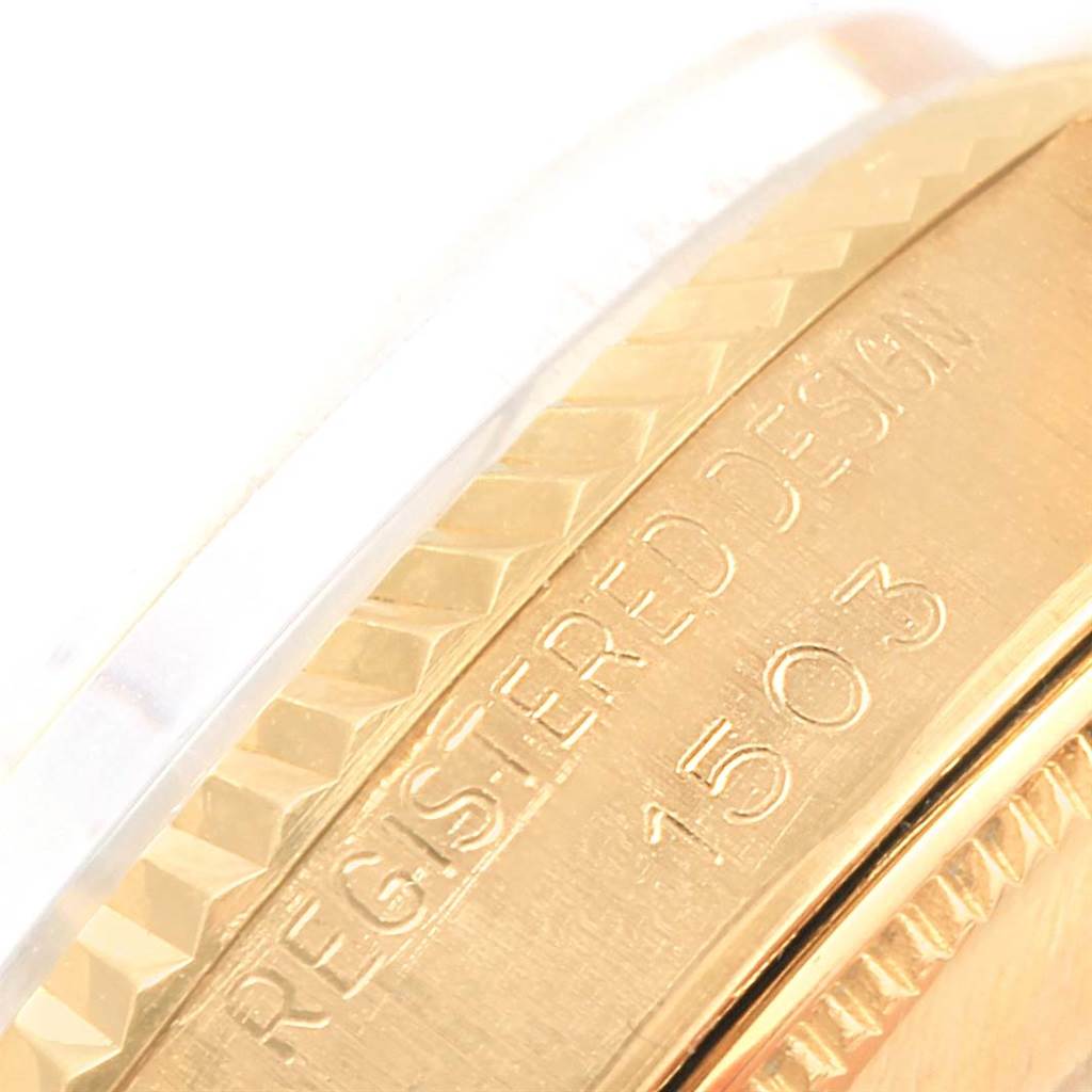 This image shows an angled close-up of the Rolex President 1503 Men's Yellow Gold Champagne Dial 1503 Men's Yellow Gold Champagne Dial model watch's bezel and the underside with engraved text.