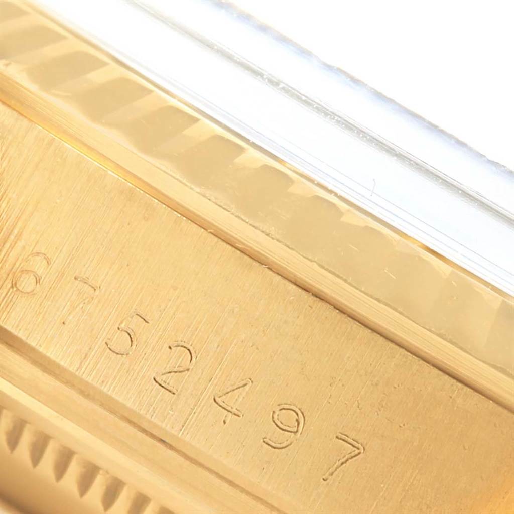The image shows a close-up of the serial number engraving on the side of a Rolex President 15037 Men
s Yellow Gold Silver Dial 15037 Men
s Yellow Gold Silver Dial model watch case.