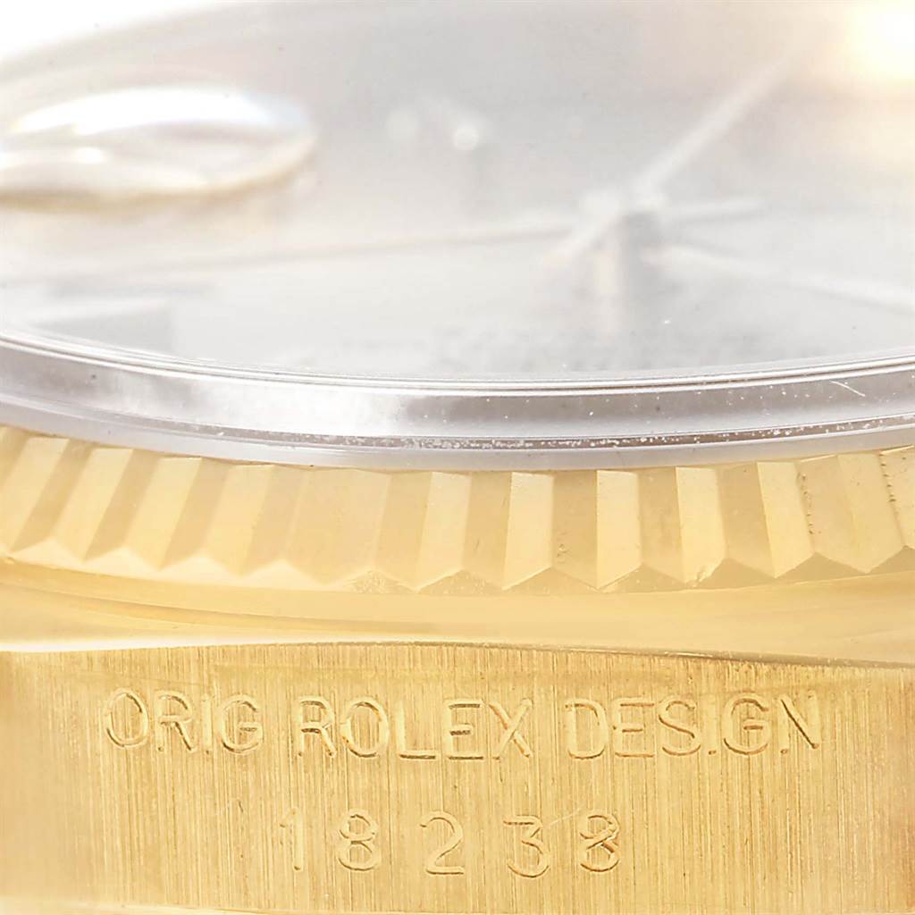 This image shows a close-up of the side of a Rolex President 18238 Men
s Yellow Gold Champagne Dial 18238 Men
s Yellow Gold Champagne Dial watch, highlighting the model number and bezel.