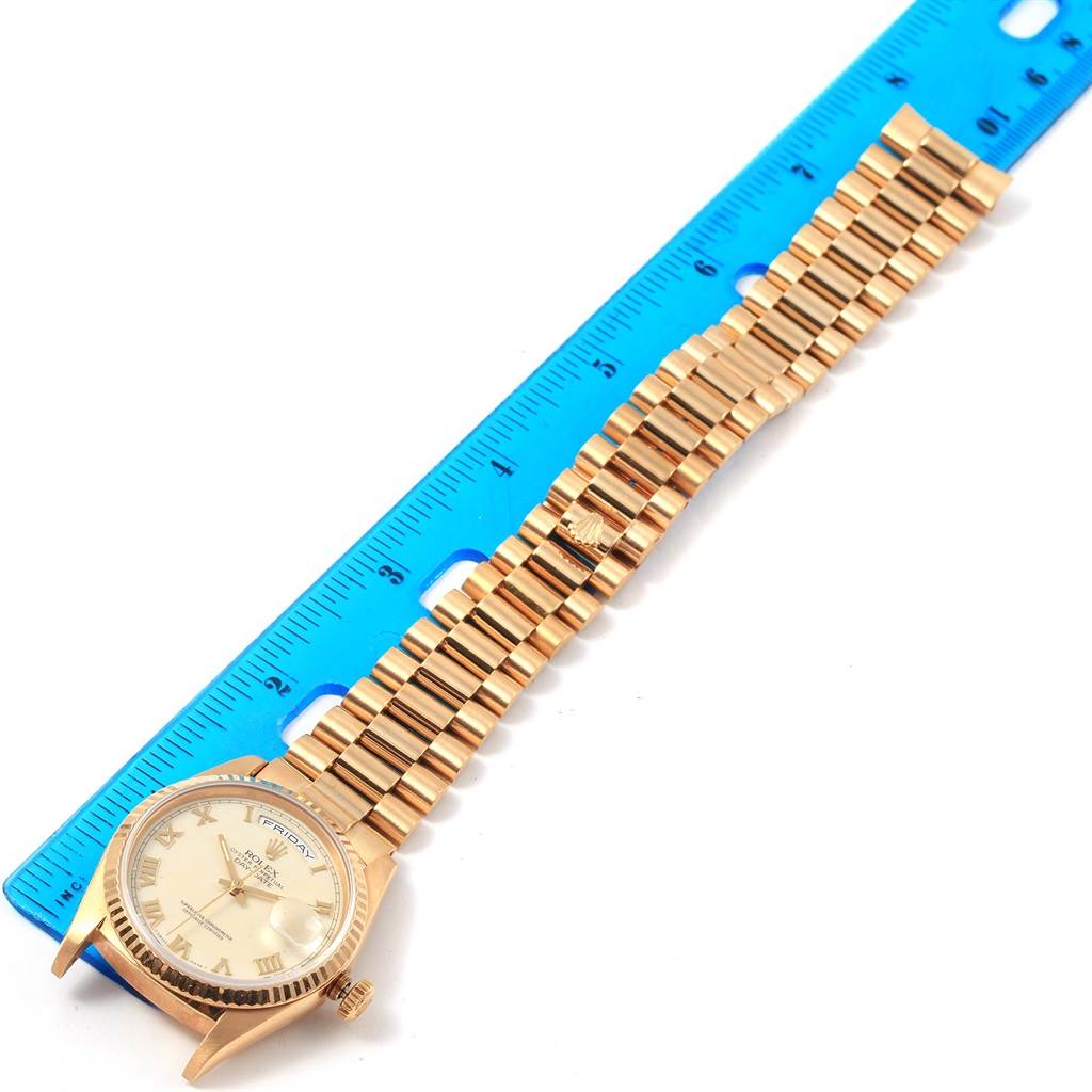 The image shows a Rolex President 18238 Men's Yellow Gold Beige Dial 18238 Men's Yellow Gold Beige Dial watch laid flat next to a blue ruler, revealing the face, case, and bracelet.