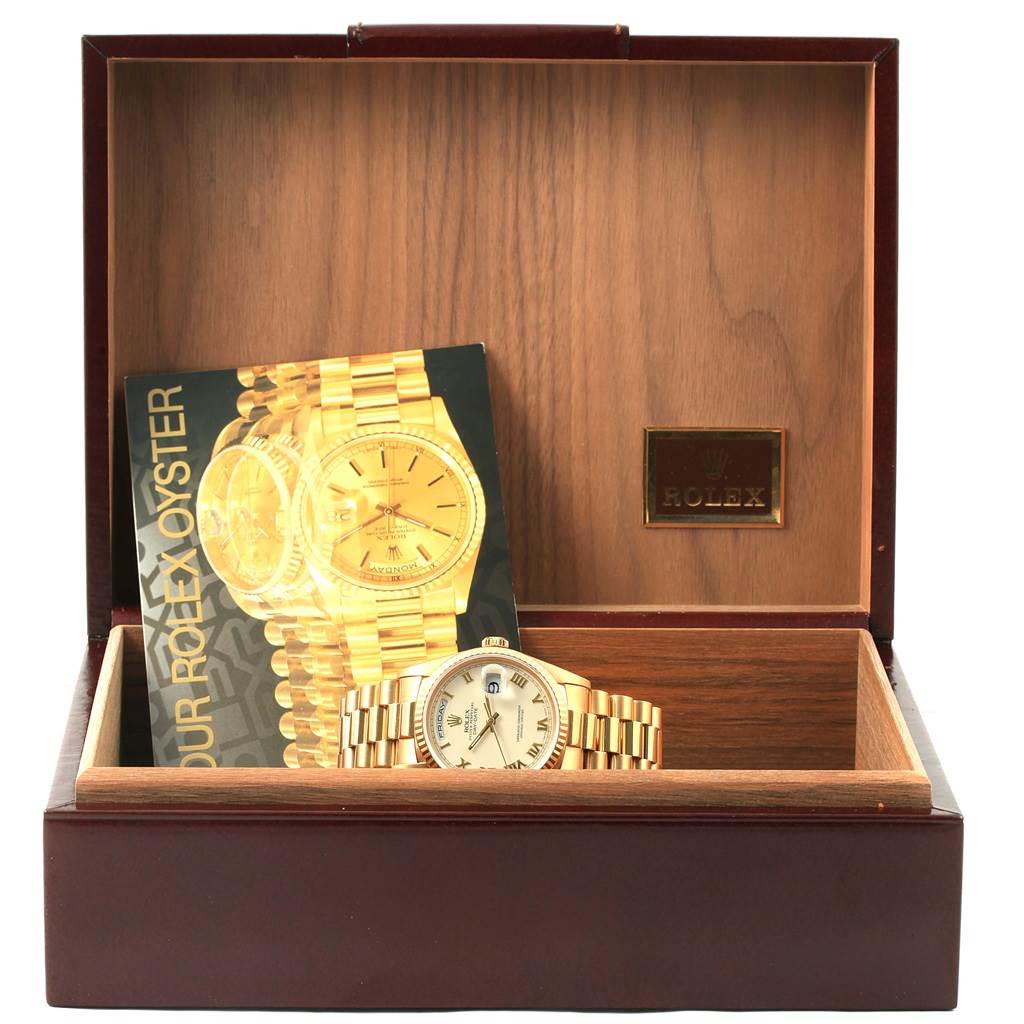 The image shows a Rolex President 18238 Men's Yellow Gold Beige Dial 18238 Men's Yellow Gold Beige Dial model watch and its booklet placed inside an open wooden box.