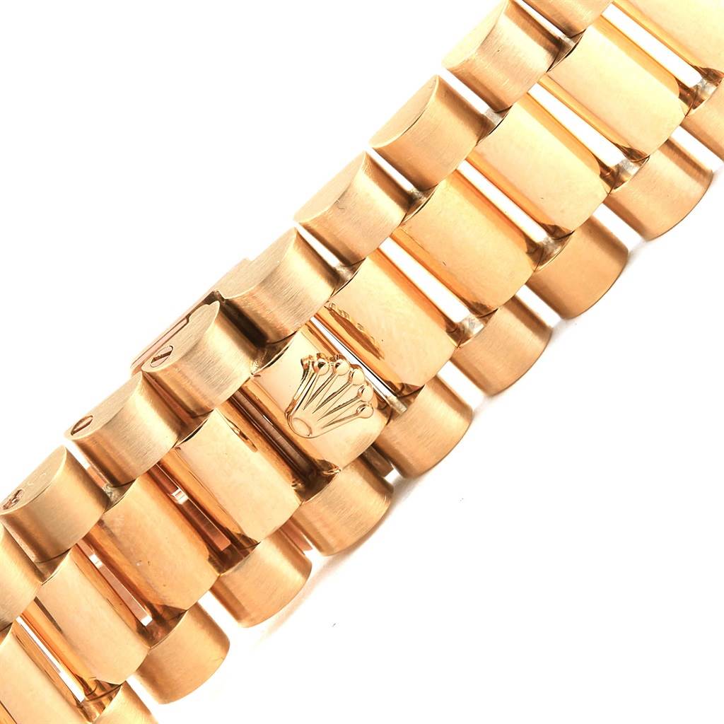 This image shows a close-up view of the bracelet of the Rolex President 18238 Men's Yellow Gold Beige Dial 18238 Men's Yellow Gold Beige Dial model, displaying the iconic crown logo on the clasp.