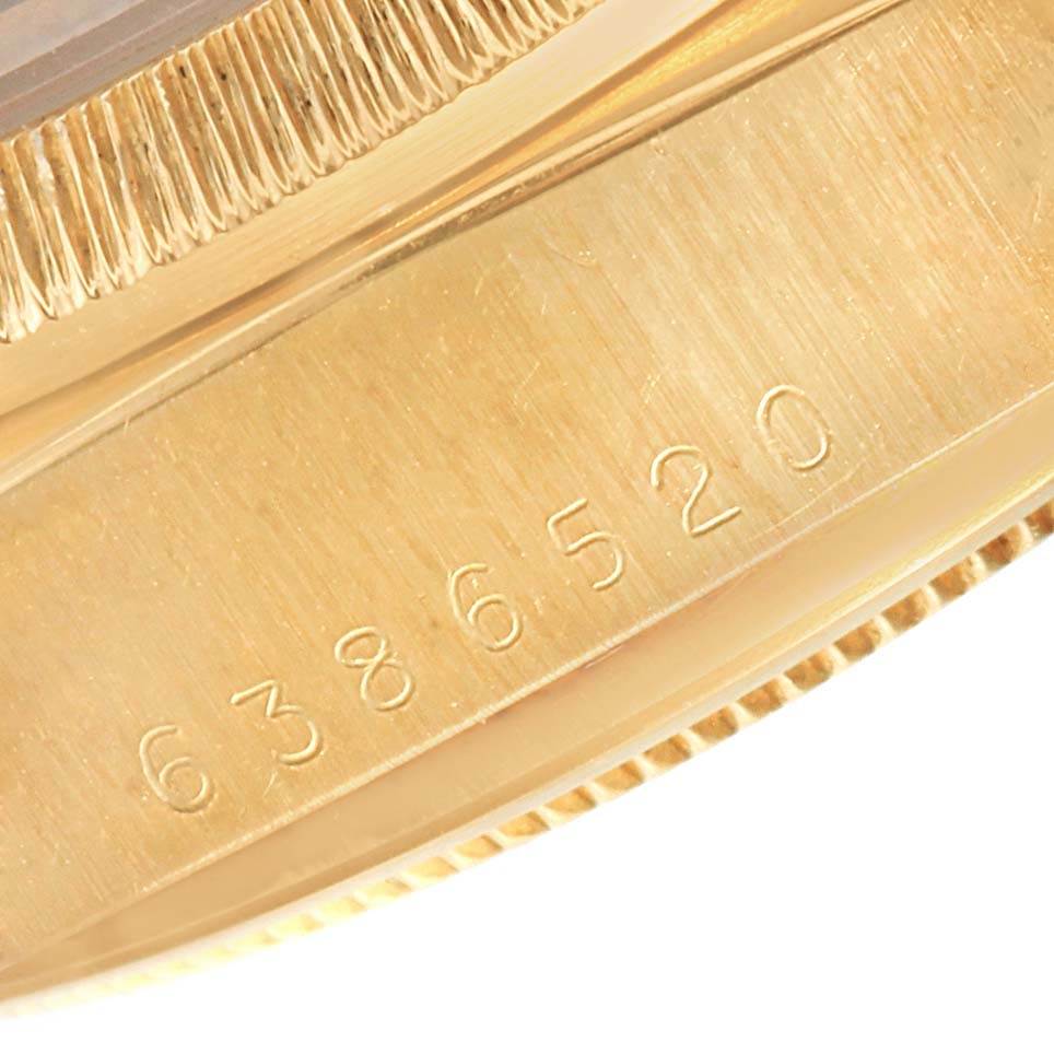 This close-up image shows the side of a Rolex President 18078 Men
s Yellow Gold Black Dial 18078 Men
s Yellow Gold Black Dial model, featuring part of the bezel and the engraved serial number.