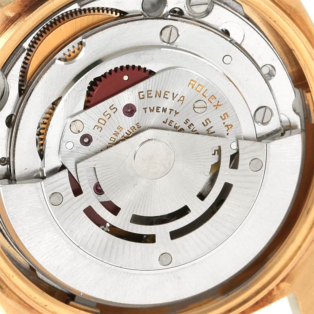This image shows the internal mechanism of a Rolex President 18078 Men
s Yellow Gold Black Dial 18078 Men
s Yellow Gold Black Dial model, viewed from the back with its intricate gears and inscription.