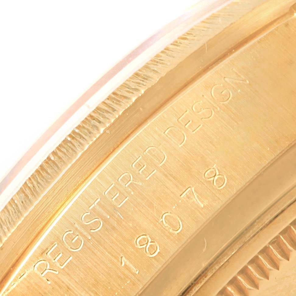 This close-up image shows the engraved detail on the case edge of the Rolex President 18078 Men
s Yellow Gold Black Dial 18078 Men
s Yellow Gold Black Dial model watch.