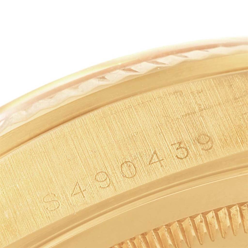 This close-up image shows the serial number engraved on the gold casing of a Rolex President 18238 Men's Yellow Gold Champagne Dial 18238 Men's Yellow Gold Champagne Dial model watch.