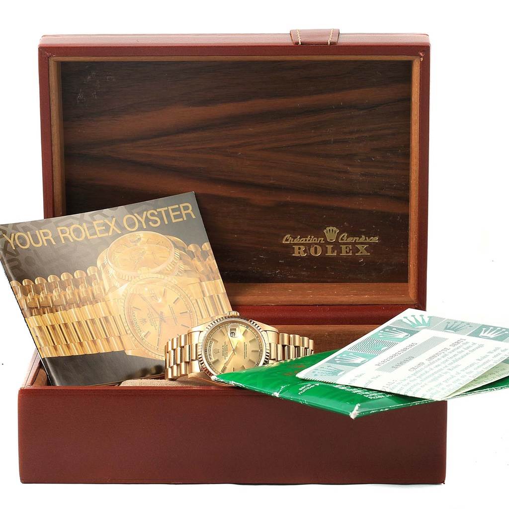 The Rolex President 18238 Men's Yellow Gold Champagne Dial 18238 Men's Yellow Gold Champagne Dial model watch is shown at a front angle within its box, along with its documentation and booklets.