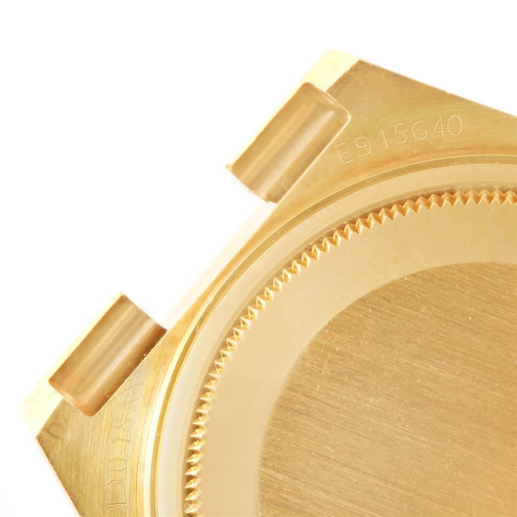 The image shows the gold caseback with serial number of a Rolex President 19018 Men's Yellow Gold Champagne Dial 19018 Men's Yellow Gold Champagne Dial model watch from an oblique angle.