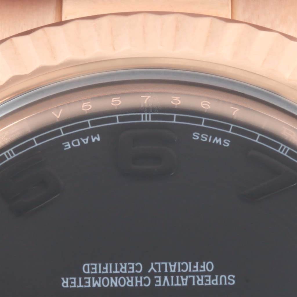 This close-up image shows the top half of the dial and bezel of the Rolex President 218235 Men's Rose Gold Black Dial 218235 Men's Rose Gold Black Dial model.