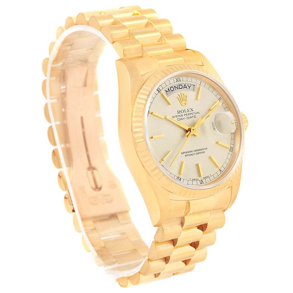 This image shows a Rolex President 18038 Men's Yellow Gold Silver Dial 18038 Men's Yellow Gold Silver Dial model watch at an angle, displaying its face, bracelet, and fluted bezel.