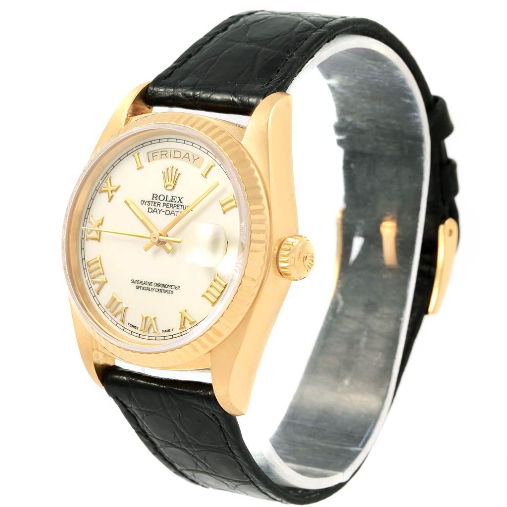 This image shows a side angle of a Rolex President 18038 Men's Yellow Gold White Dial 18038 Men's Yellow Gold White Dial watch, highlighting its face, bezel, crown, and black leather strap.