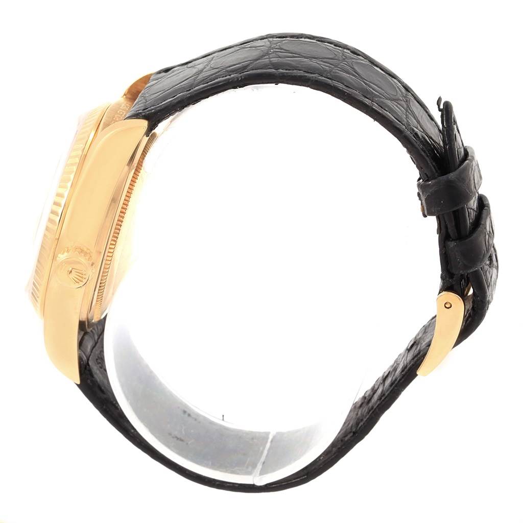 Side view of a Rolex President 18038 Men's Yellow Gold White Dial 18038 Men's Yellow Gold White Dial model watch showing the case, crown, bezel, and black leather strap with a buckle.