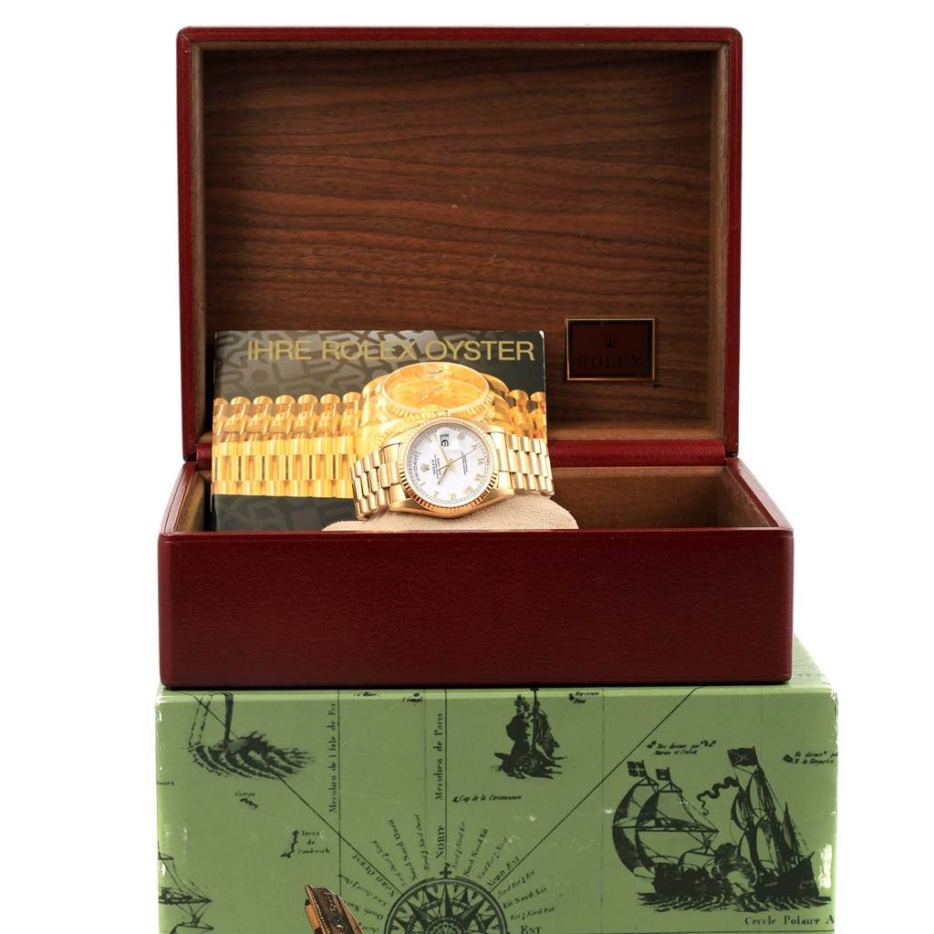 The Rolex President 18238 Men's Yellow Gold Champagne Dial 18238 Men's Yellow Gold Champagne Dial model watch is shown from a front angle, displayed in an open wooden box with its bracelet and face visible.