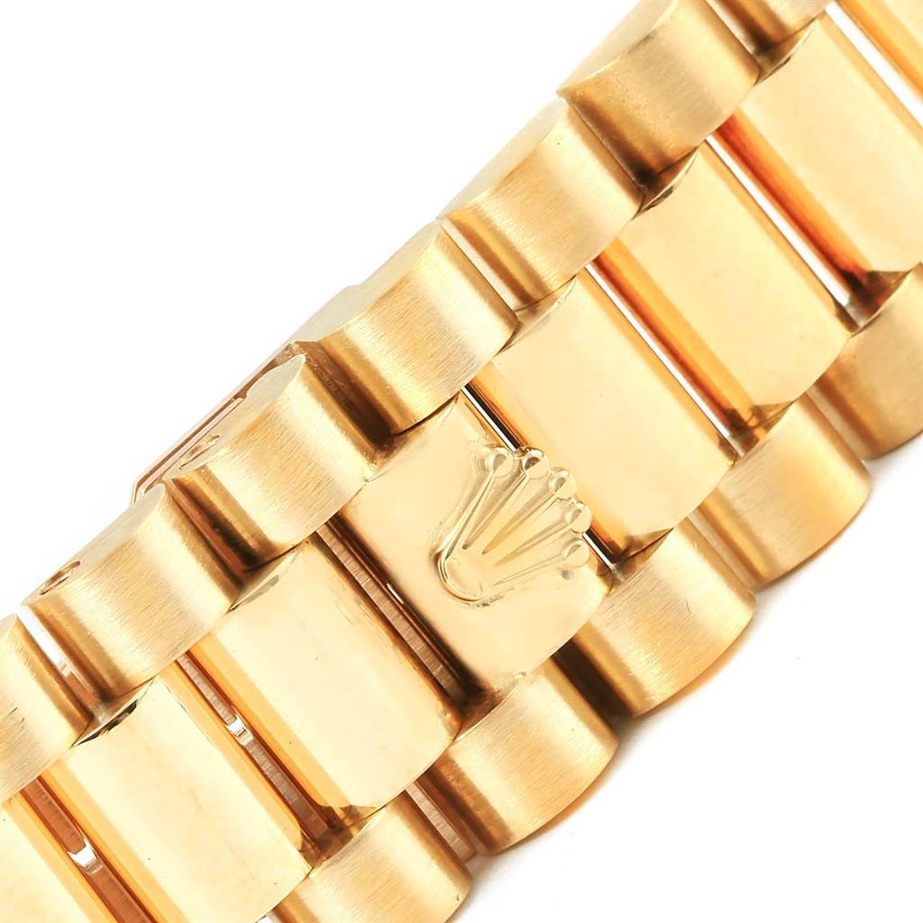 This image shows a close-up of the gold bracelet of a Rolex President 18238 Men's Yellow Gold Champagne Dial 18238 Men's Yellow Gold Champagne Dial model, highlighting the clasp with the Rolex crown logo.