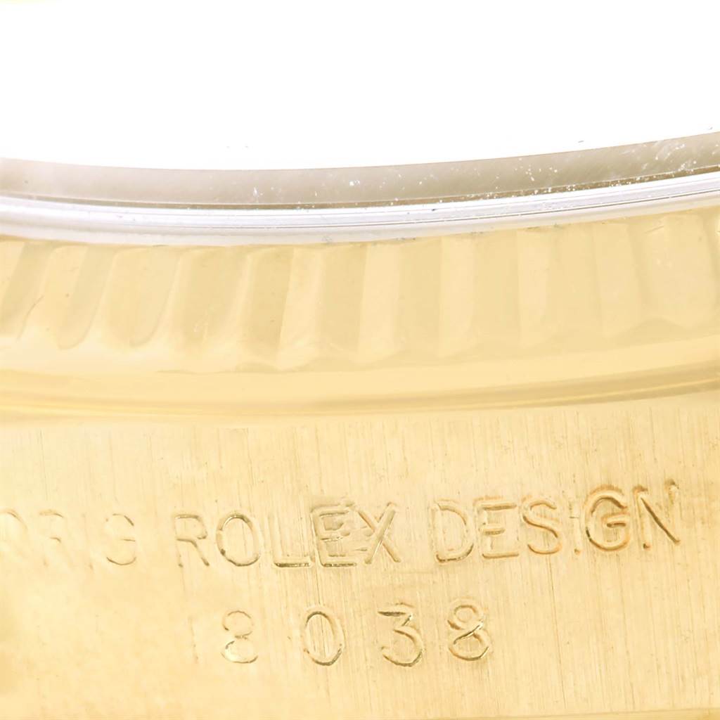 The image shows a close-up of the bezel and outer edge with the 'Rolex Design' inscription for the Rolex President 18038 Men's Yellow Gold Black Dial 18038 Men's Yellow Gold Black Dial model.