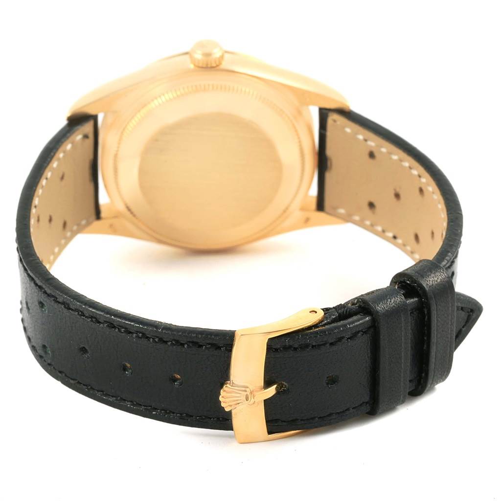 This image shows the back view of a Rolex President 15238 Men
s Yellow Gold White Dial 15238 Men
s Yellow Gold White Dial model watch, highlighting its case back and leather strap with buckle.
