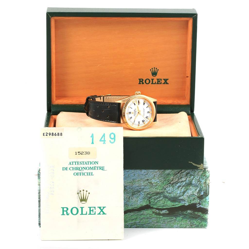The image shows a Rolex President 15238 Men
s Yellow Gold White Dial 15238 Men
s Yellow Gold White Dial model watch in its open box with a certificate in front.