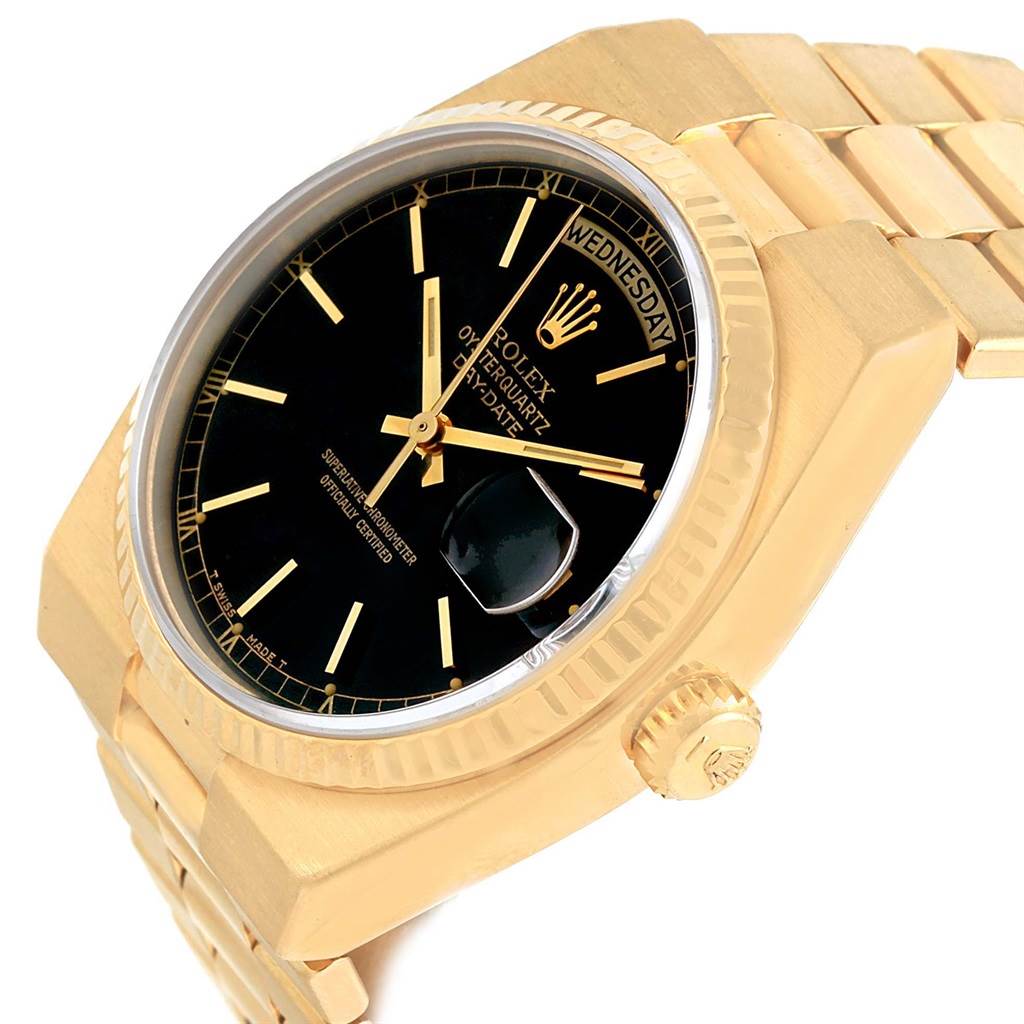 The image shows a close-up angle of a Rolex President 19018 Men
s Yellow Gold Black Dial 19018 Men
s Yellow Gold Black Dial model, highlighting its black dial, gold case, crown, and part of the bracelet.