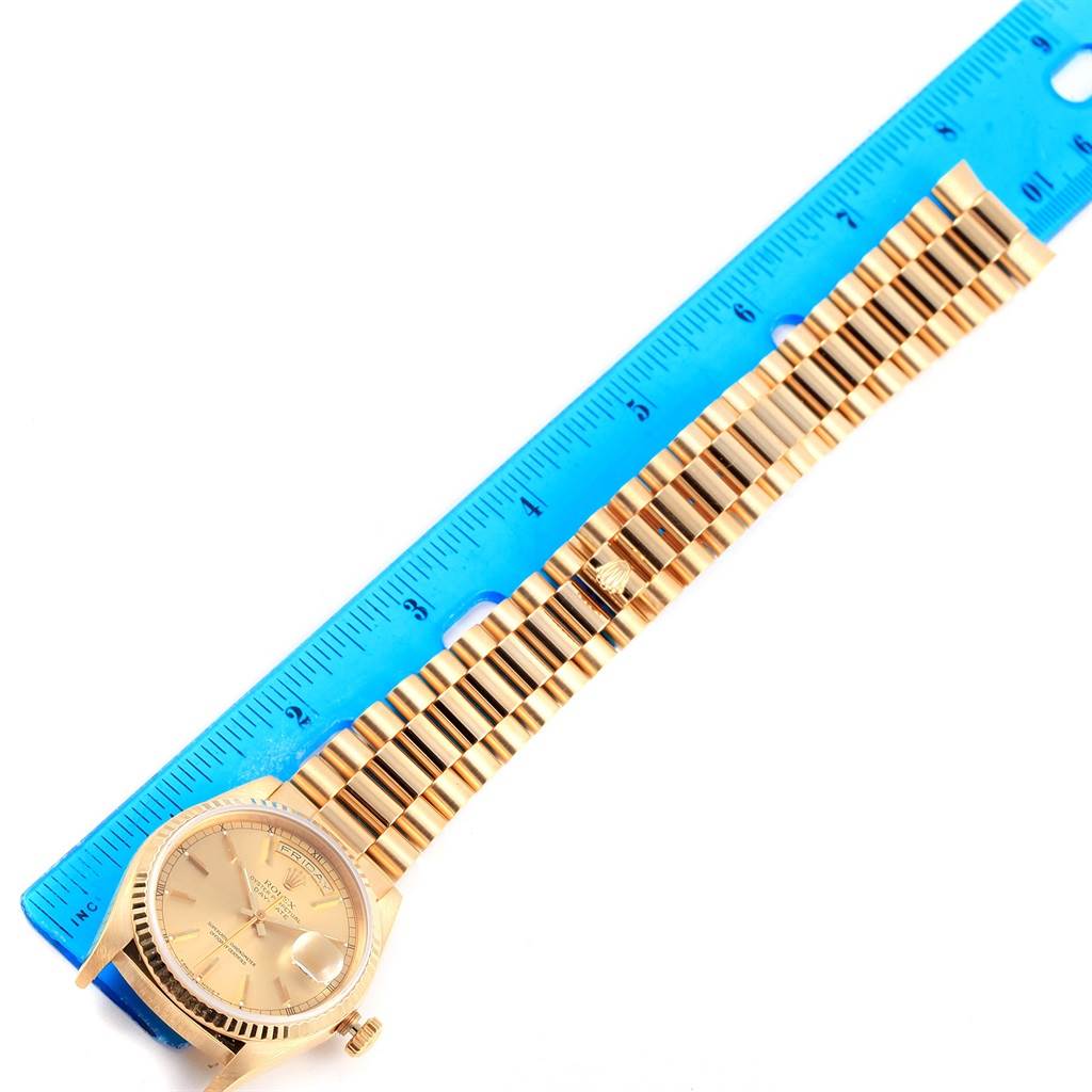 The image shows the Rolex President 18238 Men's Yellow Gold Champagne Dial 18238 Men's Yellow Gold Champagne Dial model watch laid flat with its bracelet extended and a ruler for measurement.