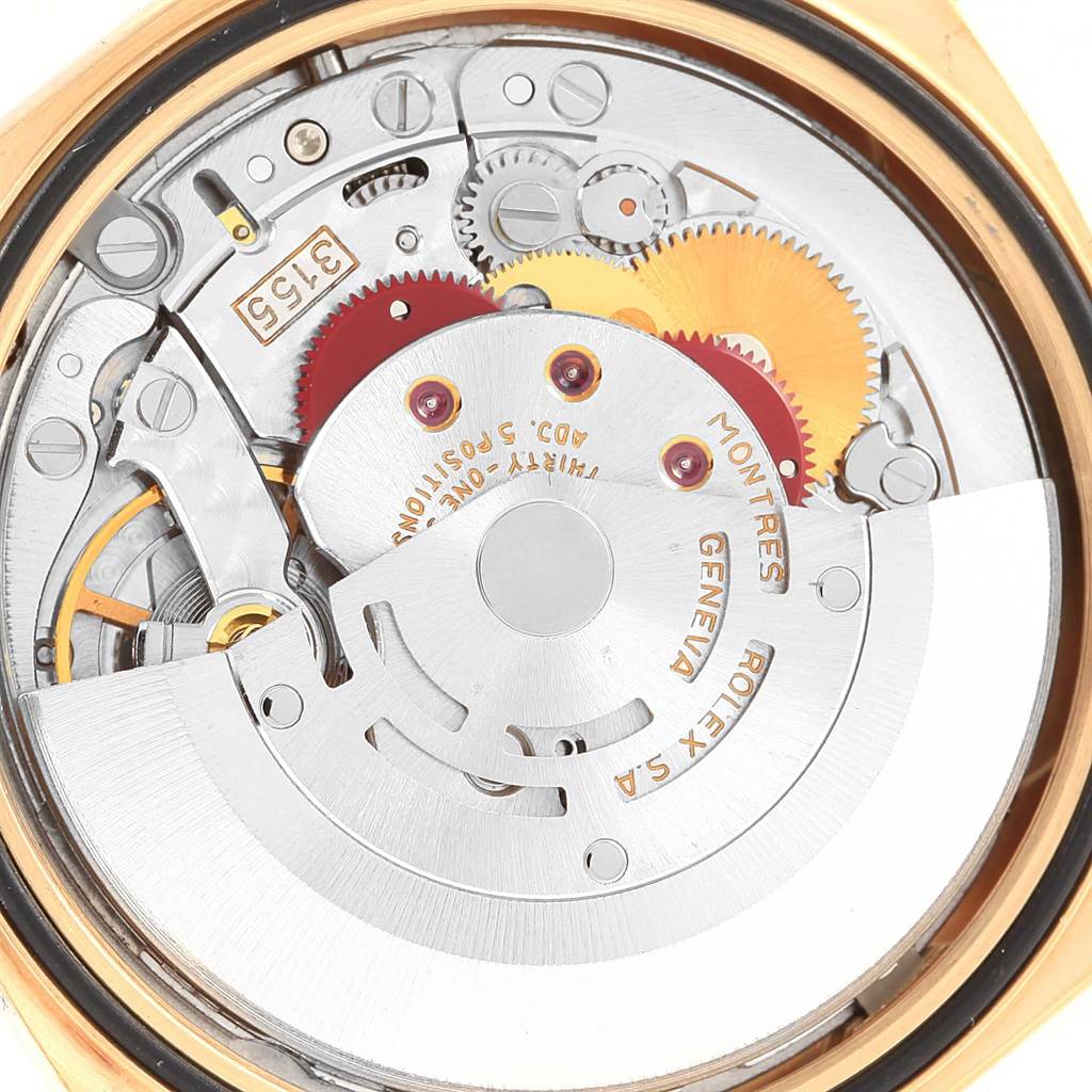The image shows an internal view of the Rolex President 18238 Men's Yellow Gold Champagne Dial 18238 Men's Yellow Gold Champagne Dial model watch, highlighting its movement and intricate gears.