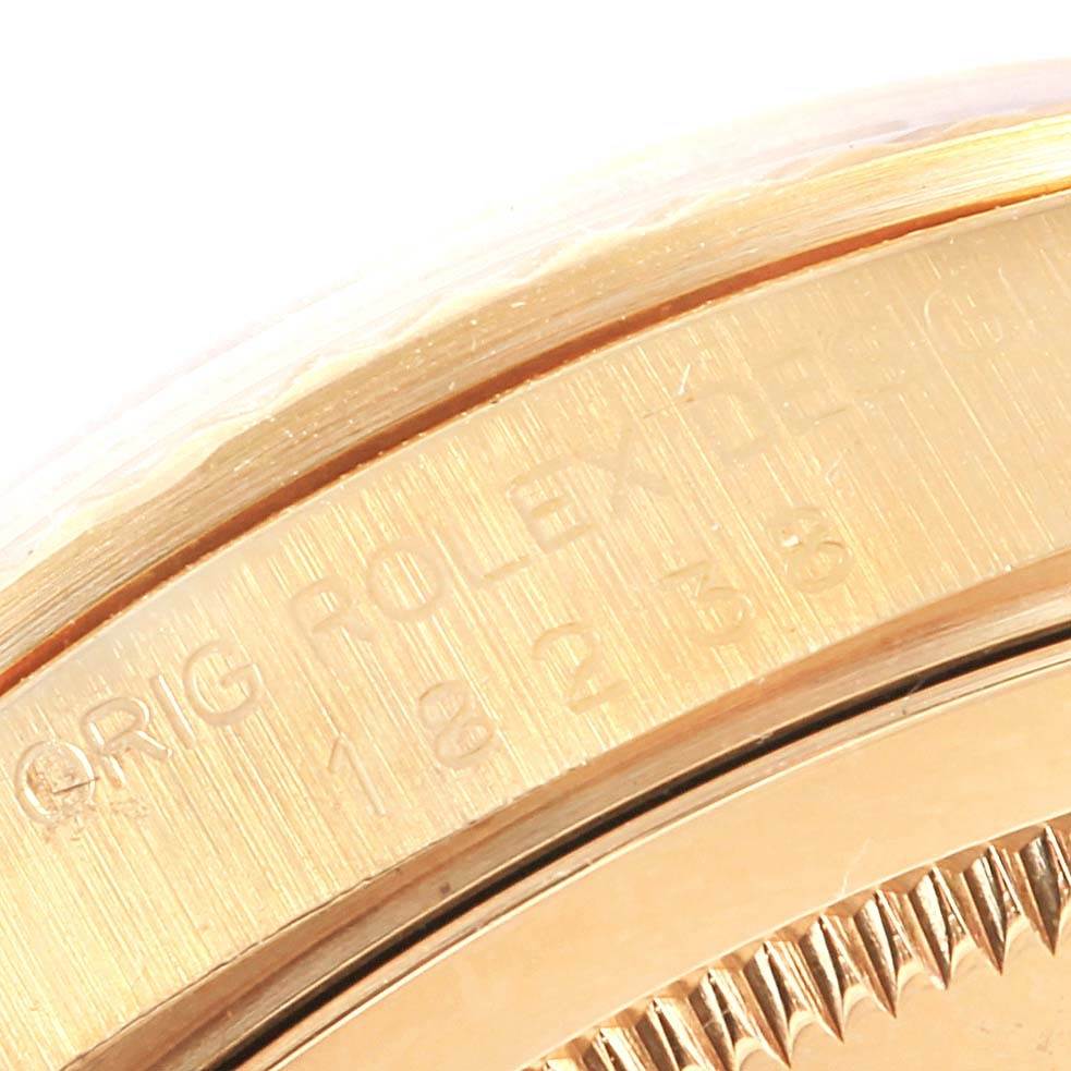 This image shows a close-up of the engraved bezel on a Rolex President 18238 Men's Yellow Gold Champagne Dial 18238 Men's Yellow Gold Champagne Dial model watch.