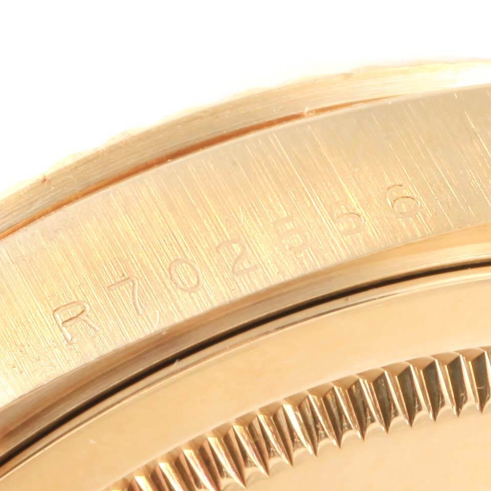 This image shows a close-up of the side and bezel of a Rolex President 18238 Men's Yellow Gold Champagne Dial 18238 Men's Yellow Gold Champagne Dial model watch, highlighting its serial number engraving.