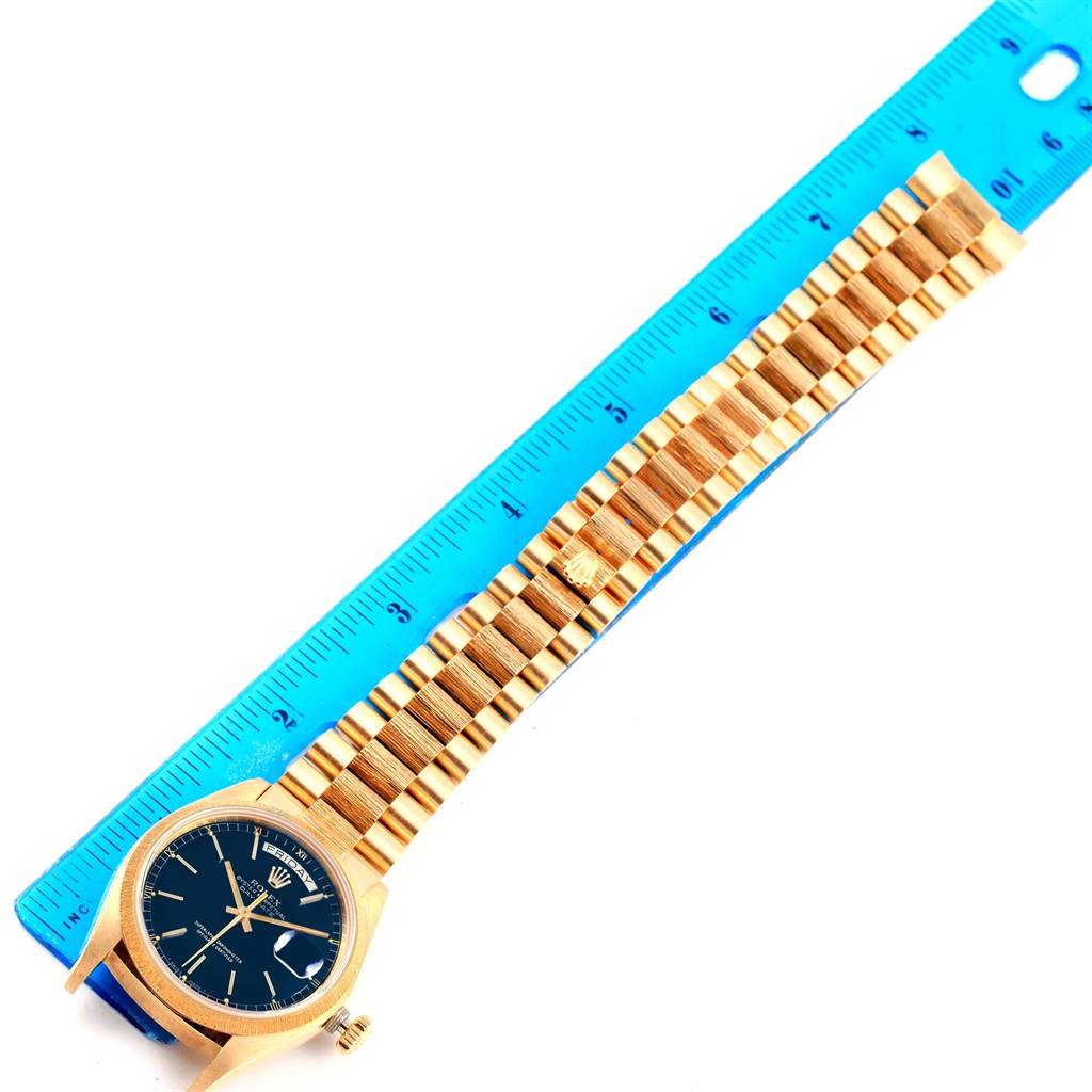 The image shows a Rolex President 18078 Men
s Yellow Gold Blue Dial 18078 Men
s Yellow Gold Blue Dial model watch positioned alongside a blue ruler, highlighting its full bracelet length.