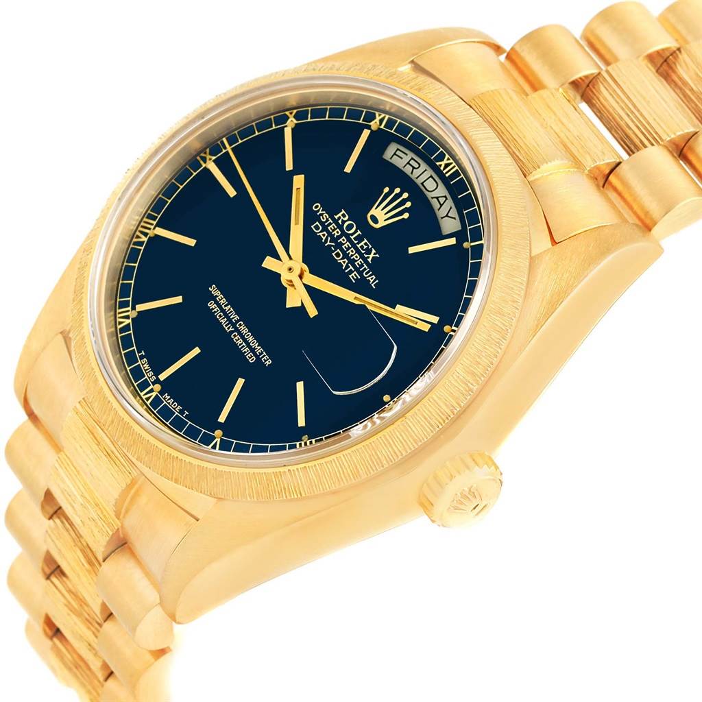 The image shows a Rolex President 18078 Men
s Yellow Gold Blue Dial 18078 Men
s Yellow Gold Blue Dial model watch at an angle highlighting its gold case, black dial, and gold bracelet.