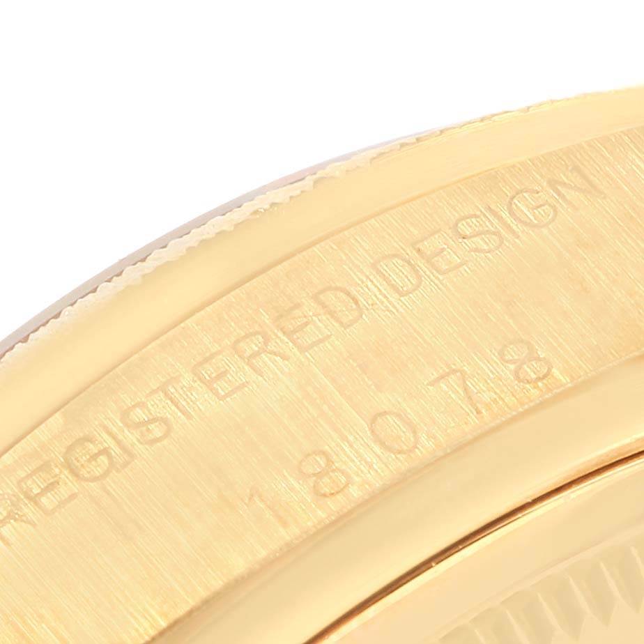 The image shows a close-up view of the engraved bezel of a Rolex President 18078 Men
s Yellow Gold Blue Dial 18078 Men
s Yellow Gold Blue Dial model watch.