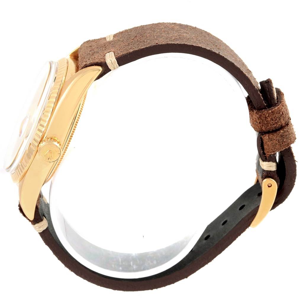 The Rolex President 1803 Men's Yellow Gold Silver Dial 1803 Men's Yellow Gold Silver Dial model watch is shown from a side angle, highlighting the case, crown, and leather strap.