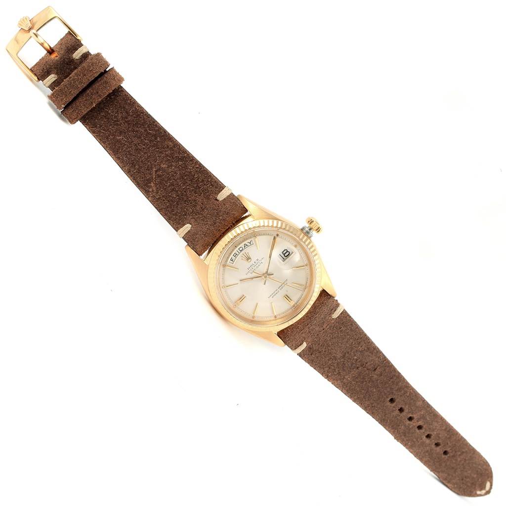 The Rolex President 1803 Men's Yellow Gold Silver Dial 1803 Men's Yellow Gold Silver Dial model watch is shown from a top-down angle, displaying its face, bezel, crown, and full leather strap.