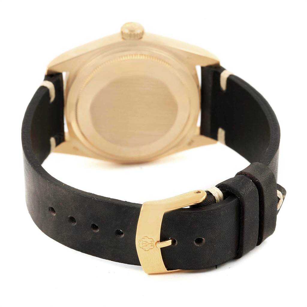 This image shows the back view of a Rolex President 18038 Men
s Yellow Gold Champagne Dial 18038 Men
s Yellow Gold Champagne Dial model watch with a black leather strap and gold buckle.
