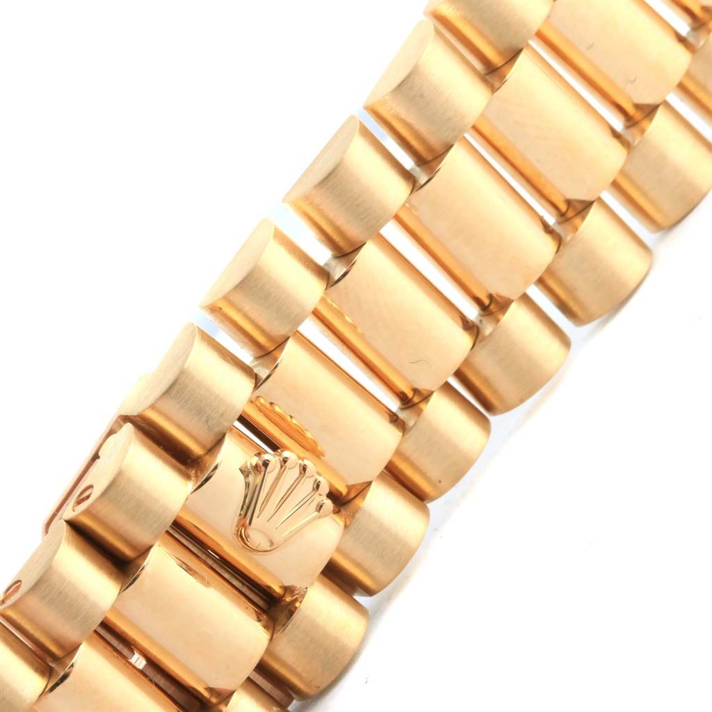 This photo shows a close-up of the gold bracelet and the Rolex crown logo on the President model by Rolex.