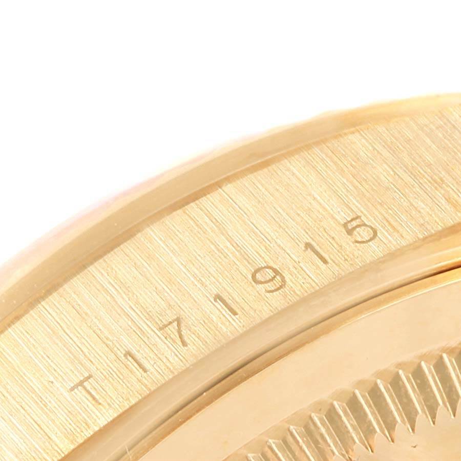 This is a close-up angle of the side of a Rolex President 18238 Men
s Yellow Gold Champagne Dial 18238 Men
s Yellow Gold Champagne Dial model watch, showing the serial number engraved on the bezel.