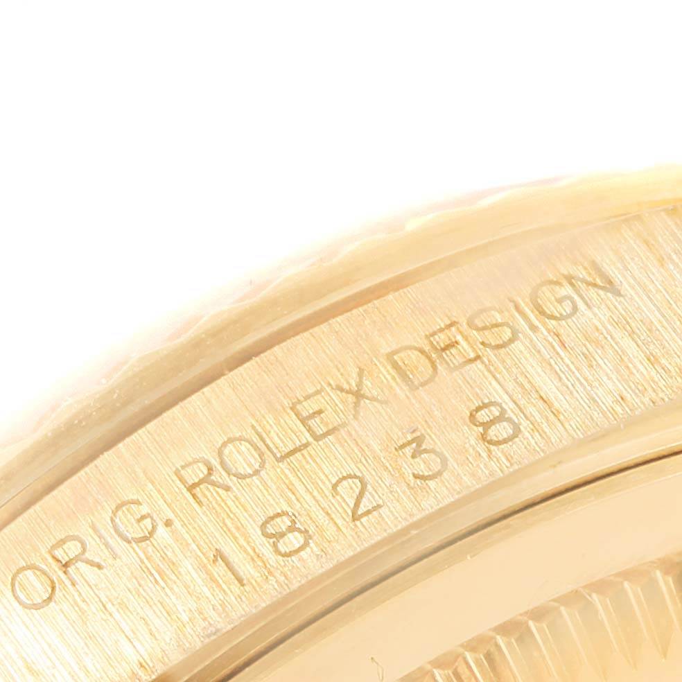 The image shows a close-up of the serial number and part of the bezel on a Rolex President 18238 Men
s Yellow Gold Champagne Dial 18238 Men
s Yellow Gold Champagne Dial watch.