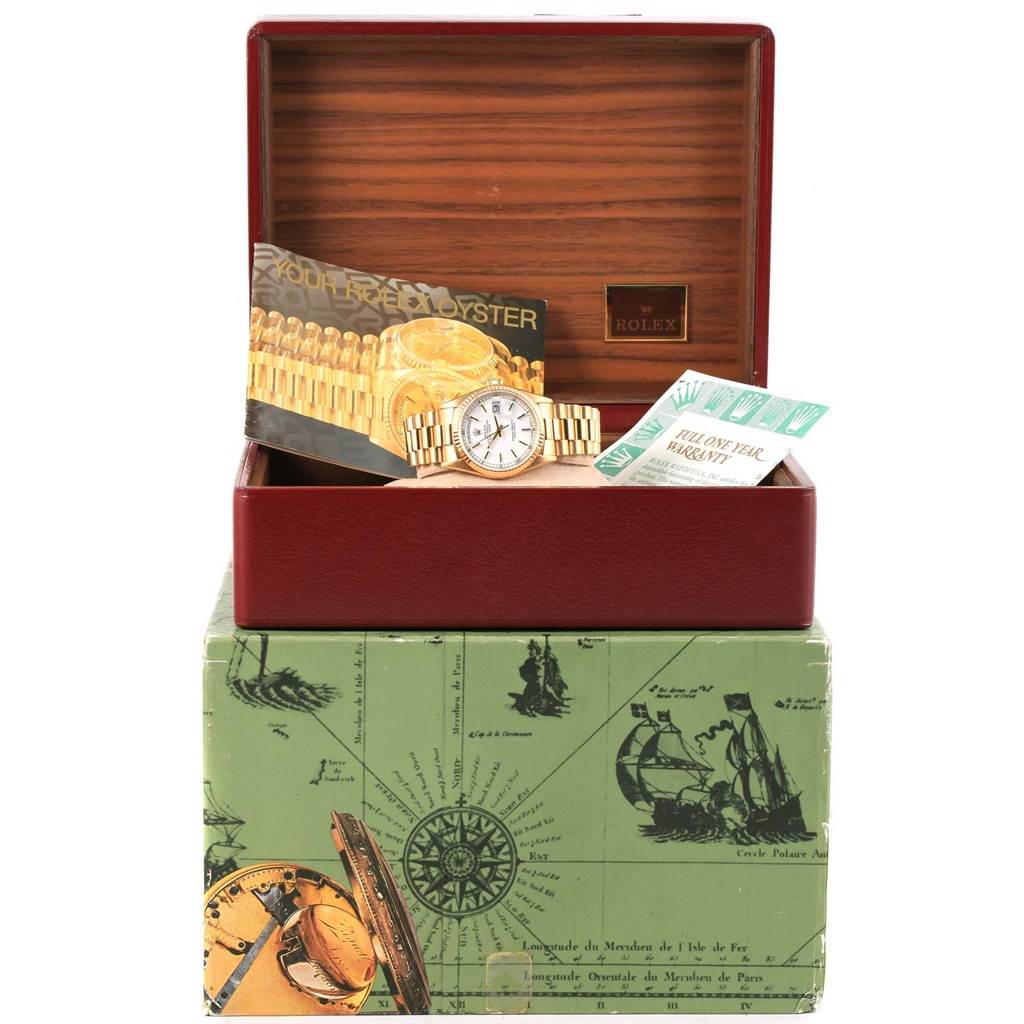 The Rolex President 18238 Men
s Yellow Gold White Dial 18238 Men
s Yellow Gold White Dial watch is displayed in an open box with warranty cards and promotional material.