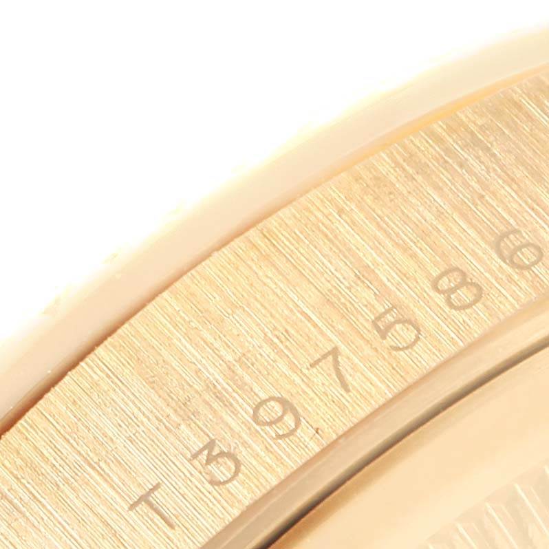 The image shows a close-up of the bezel with numbers of a Rolex President 18238 Men
s Yellow Gold White Dial 18238 Men
s Yellow Gold White Dial model watch.
