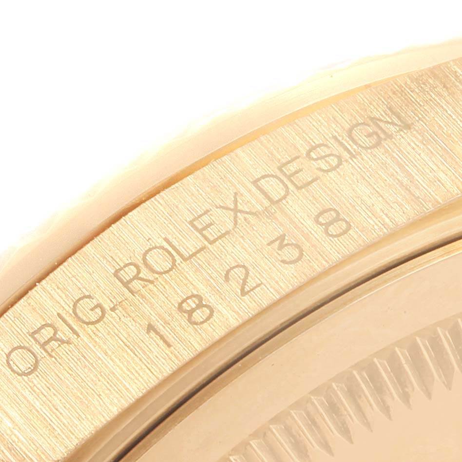 The image shows a close-up view of the caseback edge of the Rolex President 18238 Men
s Yellow Gold White Dial 18238 Men
s Yellow Gold White Dial, highlighting the engravings.
