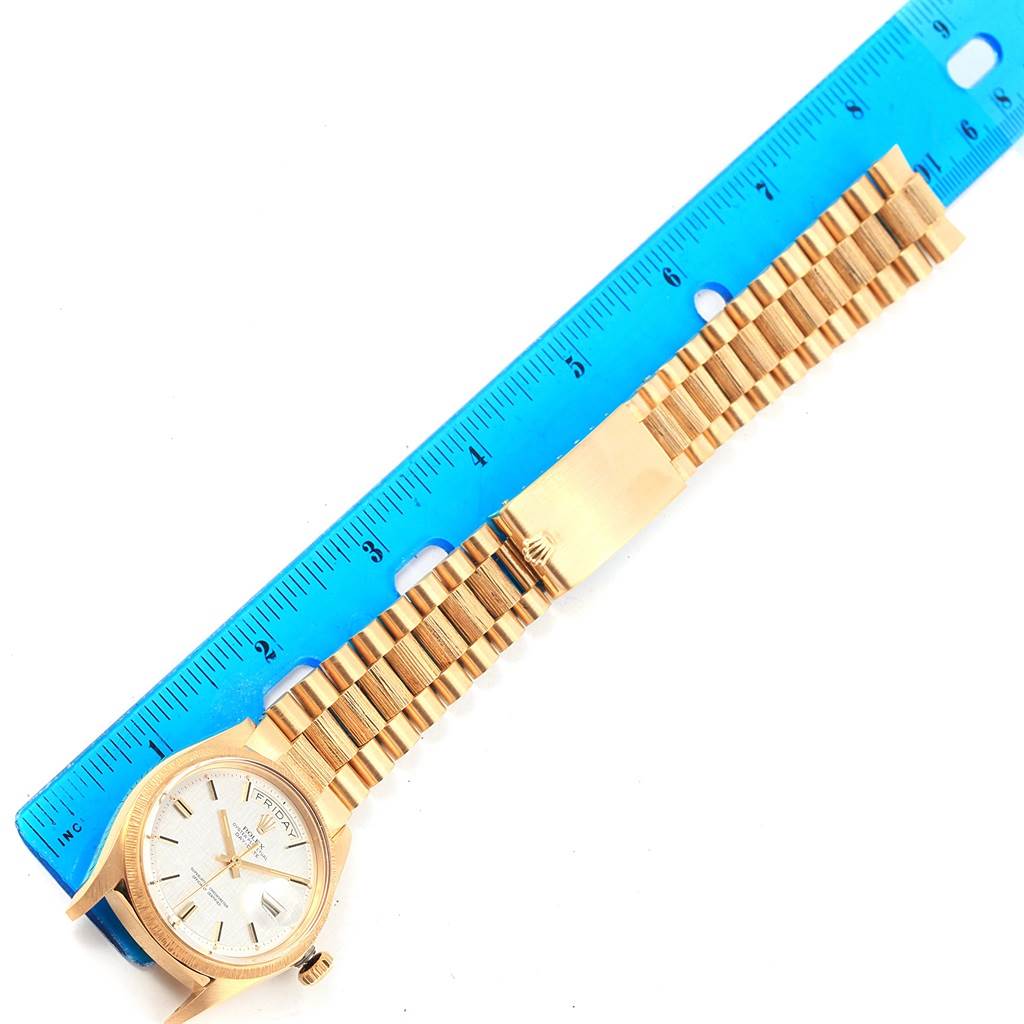 The image shows a Rolex President 1807 Men's Yellow Gold Silver Dial 1807 Men's Yellow Gold Silver Dial model watch laid flat next to a blue ruler, displaying the watch face and gold bracelet.