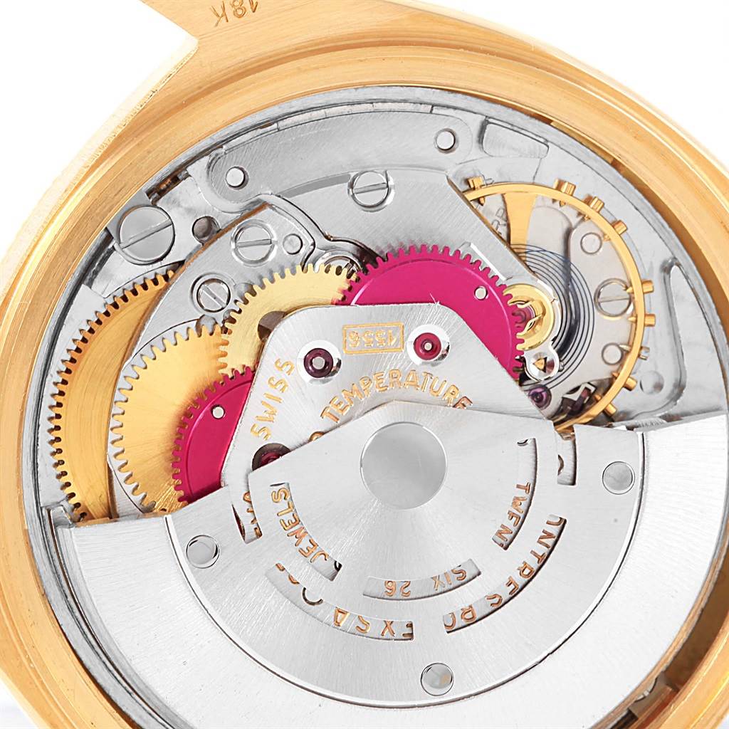 The image shows a close-up of the internal mechanism of a Rolex President 1807 Men's Yellow Gold Silver Dial 1807 Men's Yellow Gold Silver Dial model watch, highlighting gears and intricate components.