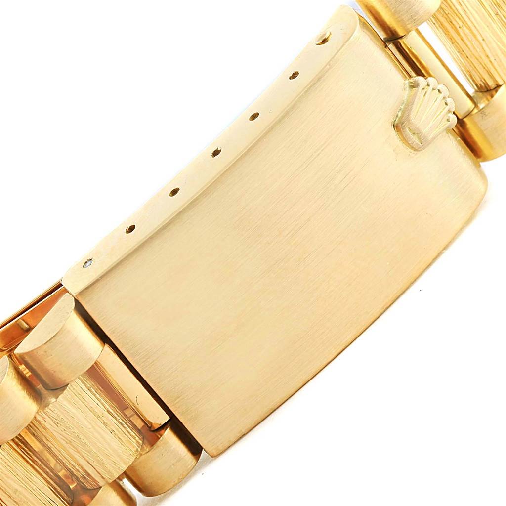 This image shows a close-up of the clasp and part of the bracelet of a Rolex President 1807 Men's Yellow Gold Silver Dial 1807 Men's Yellow Gold Silver Dial model watch.
