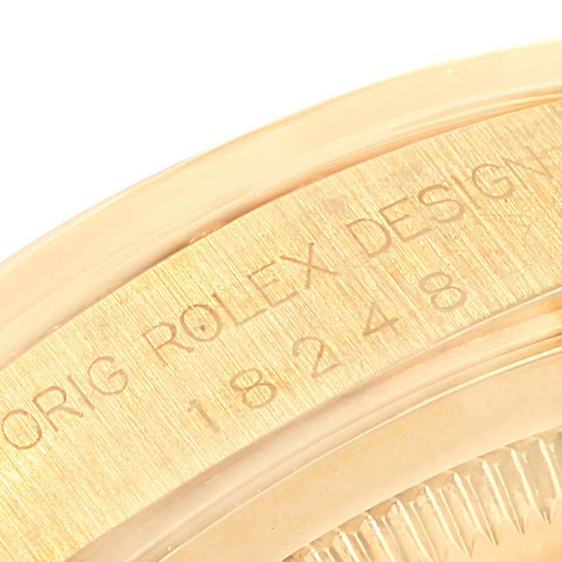 This image shows a close-up of the engraved case back edge of a Rolex President watch.